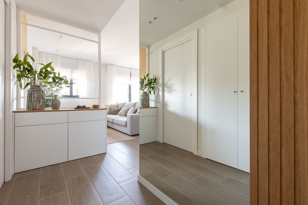 Recibidor con mueble a medida y espejo de suelo a techo. 