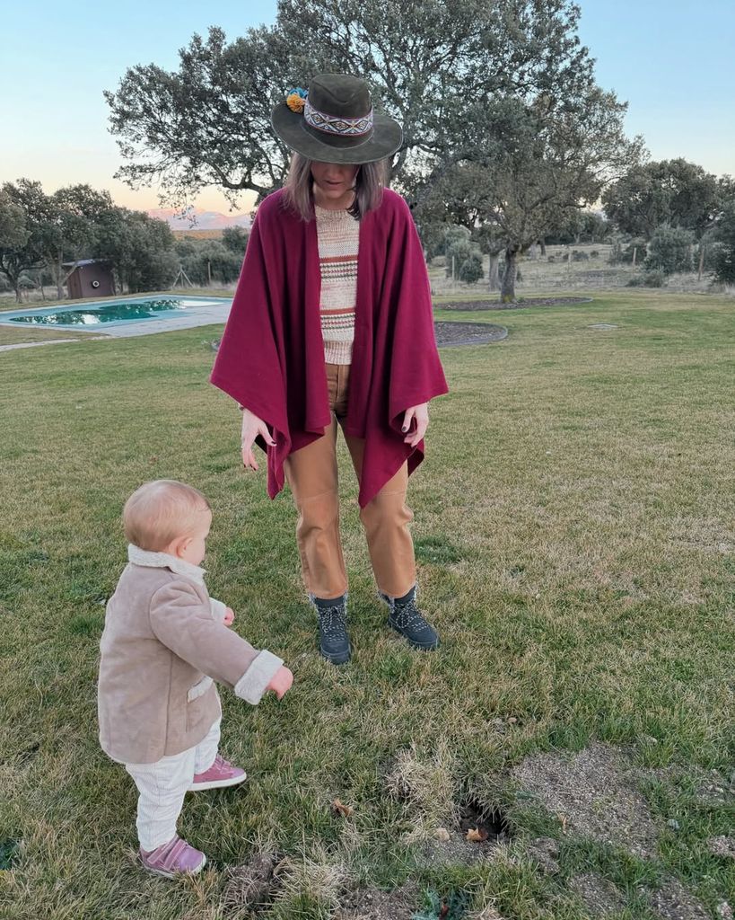 Isabelle Junot con capa y sombrero, junto a su hija en el campo