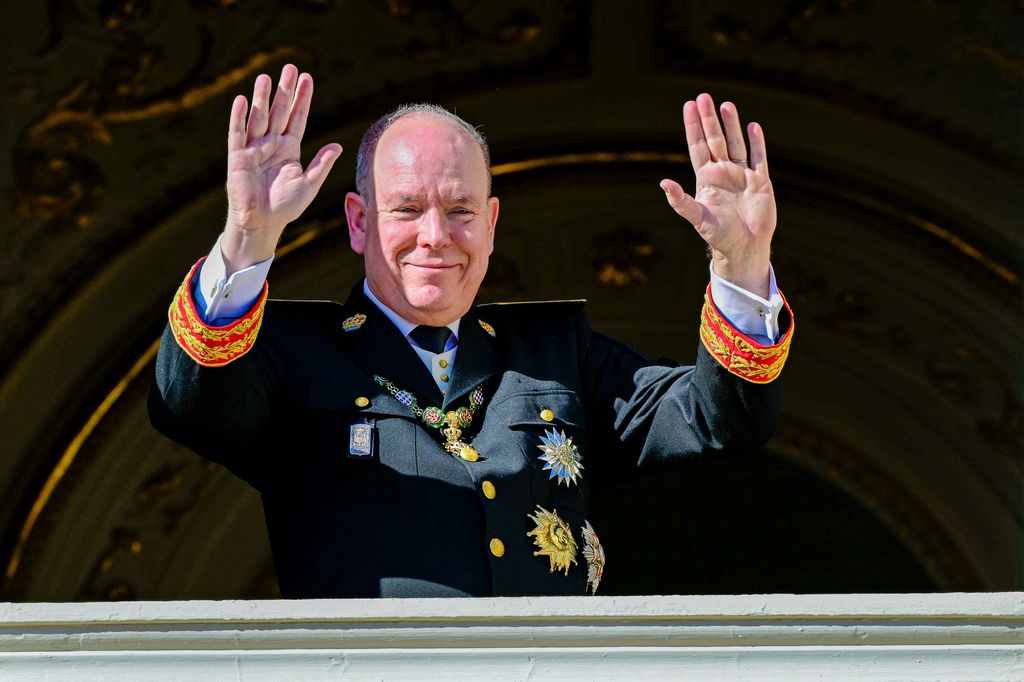 Albert II, Príncipe de Mónaco, en uniforme militar, saludando desde un balcón.