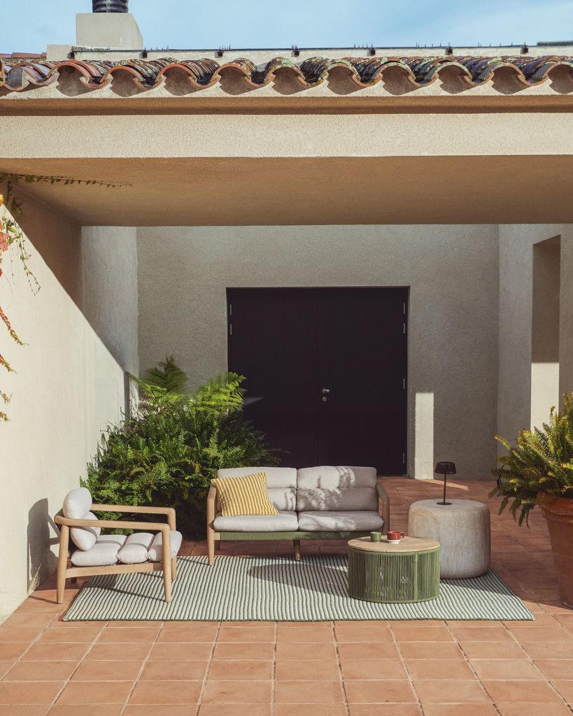 Salón de verano con muebles de madera y toques verdes