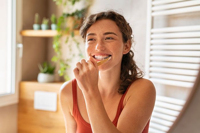 mujer lavándose los dientes