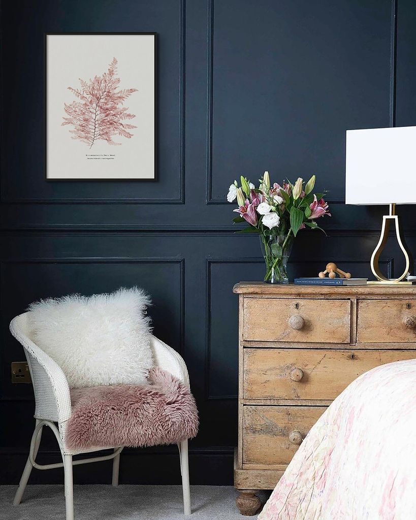 Pared oscura decorada con una lámina blanca