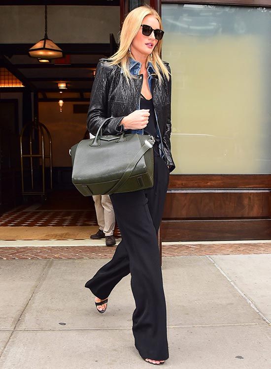 La modelo luce un total look black compuesto por una cazadora de cuero negra con una camisa abierta denim de Aritzia, un top lencero, unos pantalones de corte palazzo con detalles de cuerdas, sandalias de Gianvitto Rossi y gafas negras de Saint Laurent. Un sofisticado outfit al que añadió unas notas rock con la elección de esta 'chupa' con hombros armados, de acabado brillante y cremalleras en plata.
