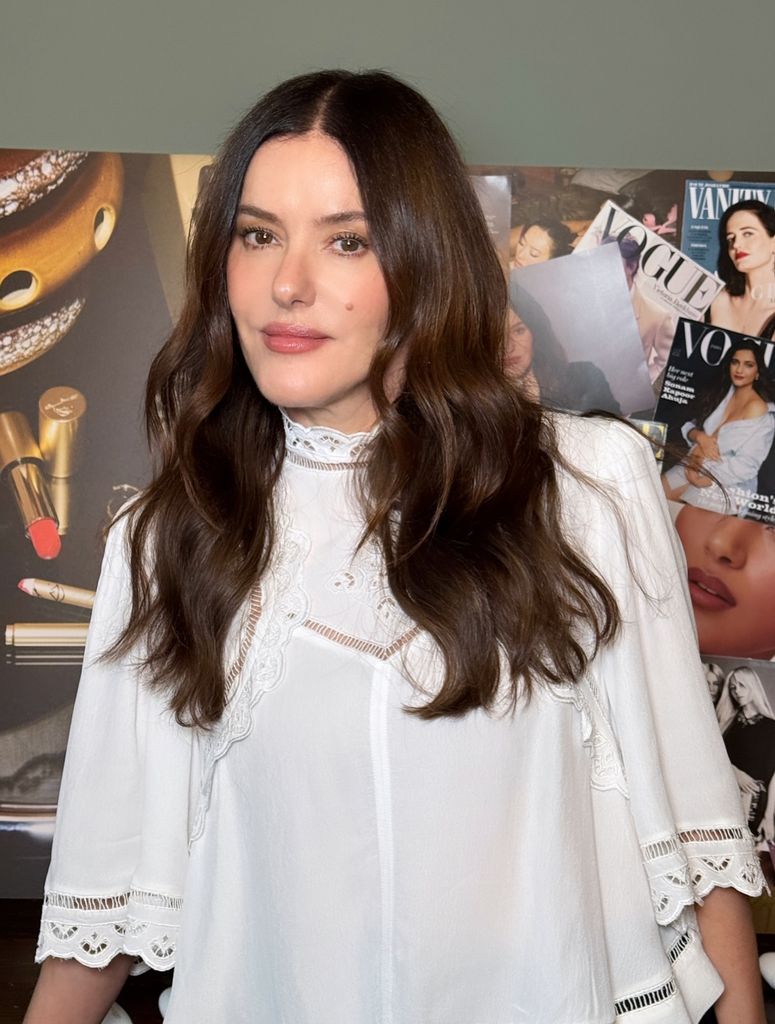 Retrato de Lisa Eldridge con blusa blanca con encaje, pelo suelto y maquillaje natural