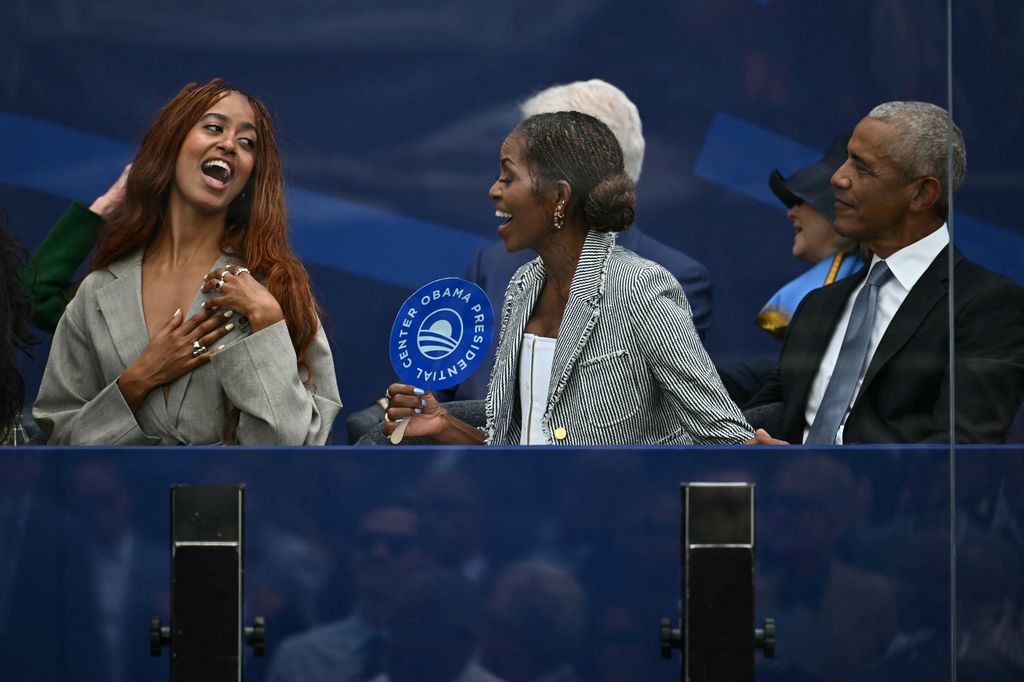 Barack y Michelle Obama con su hija Malia