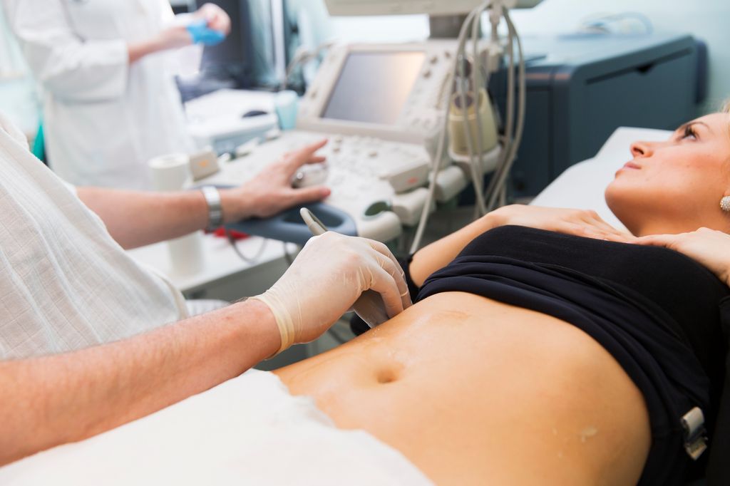 Mujer con ecografía en el abdomen