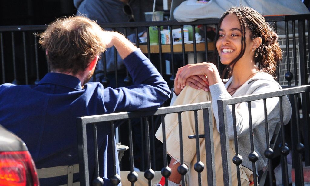 Malia Obama smiling getting coffee with friend