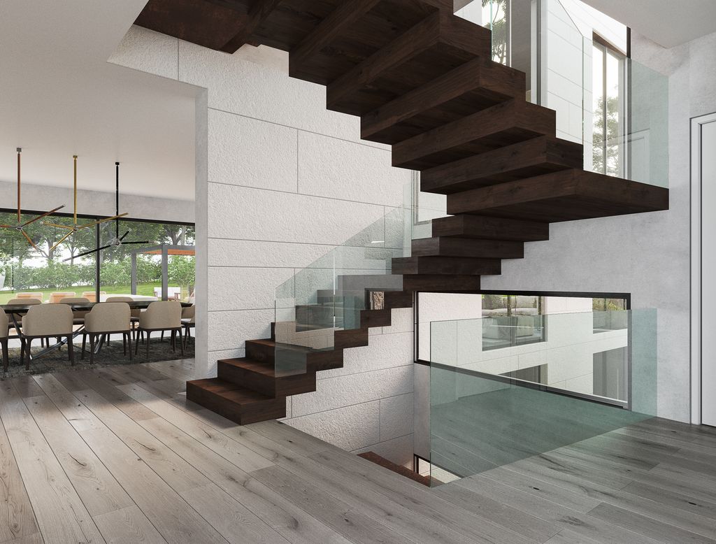 Vivienda unifamiliar con una imponente escalera que conduce a las distintas plantas