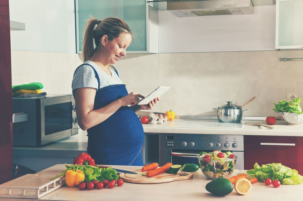 Mujer embarazada en la cocina