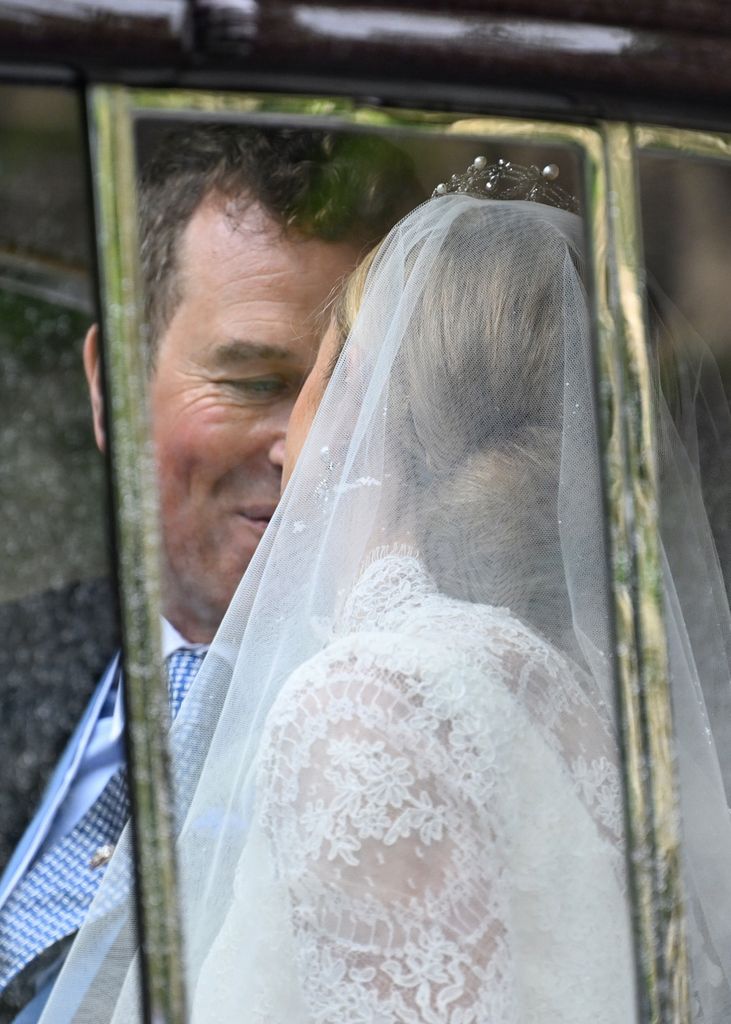 Beso de los recién casados dentro de coche nupcial