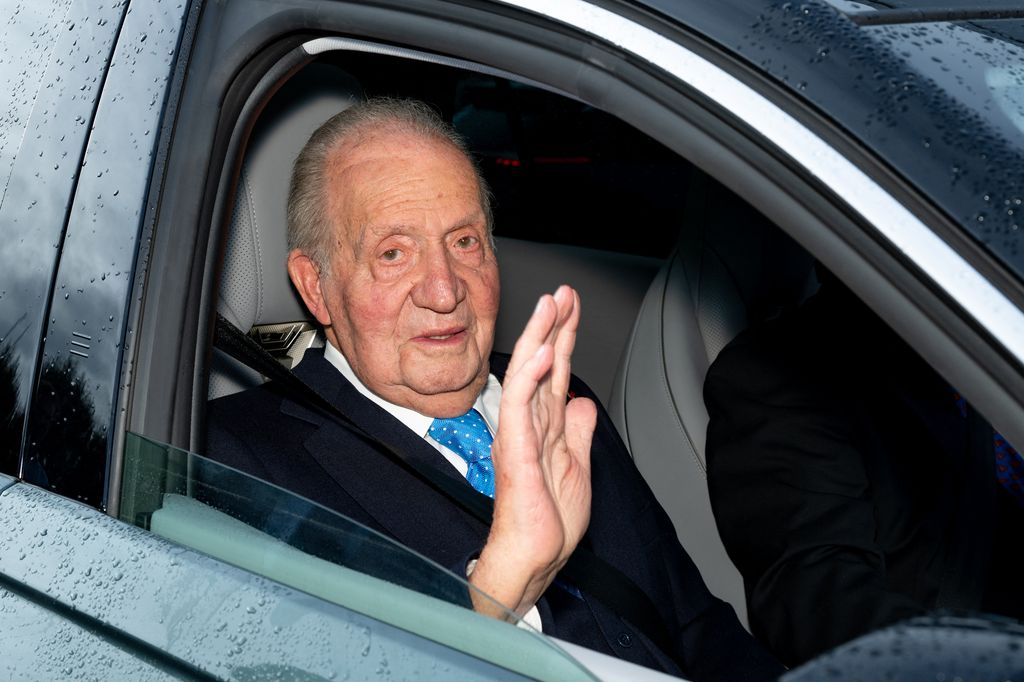 Juan Carlos I, subido ya al coche que lo llevaba, se despide tras el acto