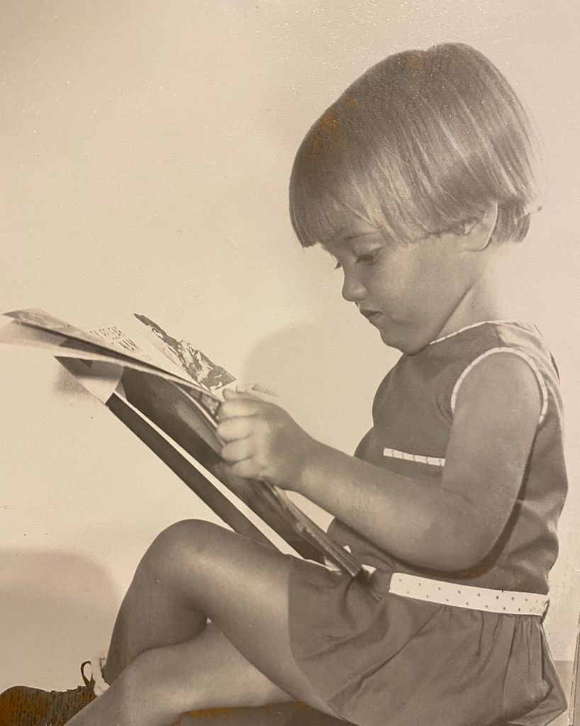 Amparo Aragón, de niña, leyendo una revista
