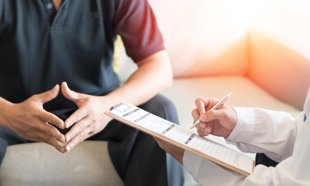 Urologist Doctor giving consult for prostate problems to patient. Urologic oncologists specialize in treating cancer of the urinary tract and male reproductive organs. Mens health problem concept.