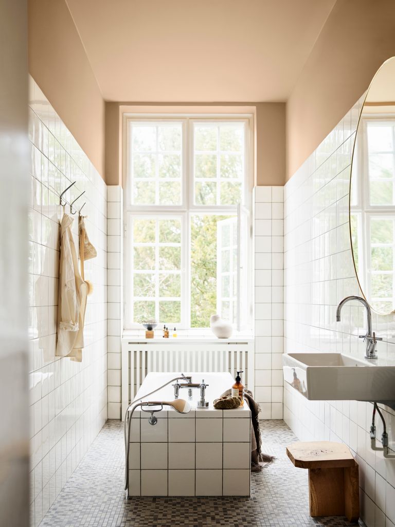 Baño con azulejos blancos y pintura de color maquillaje