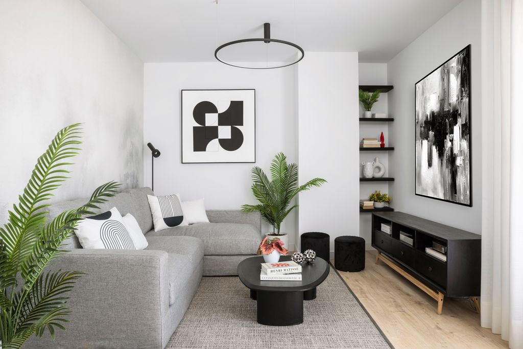 Salón con sofá con chaise longue gris y pufs de color negro