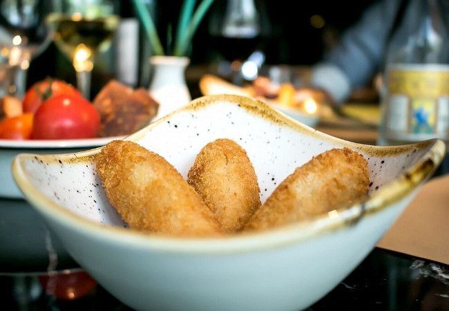 Las 'croquetas de pollo' de Xibarri se han ganado a pulso la merecida fama de la que gozan, con un crujiente rebozado exterior y una suave masa de pollo 'rustido' en el interior.

