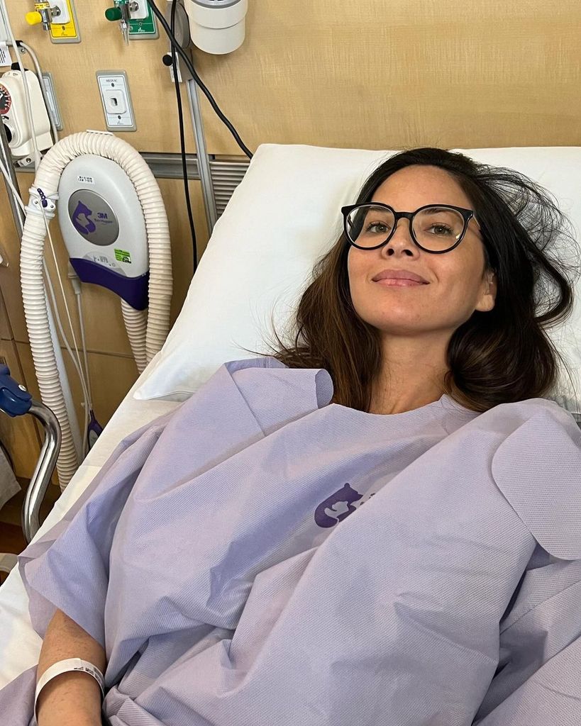 Olivia Munn tumbada en una camilla de hospital en sus tratamientos de cáncer de mama