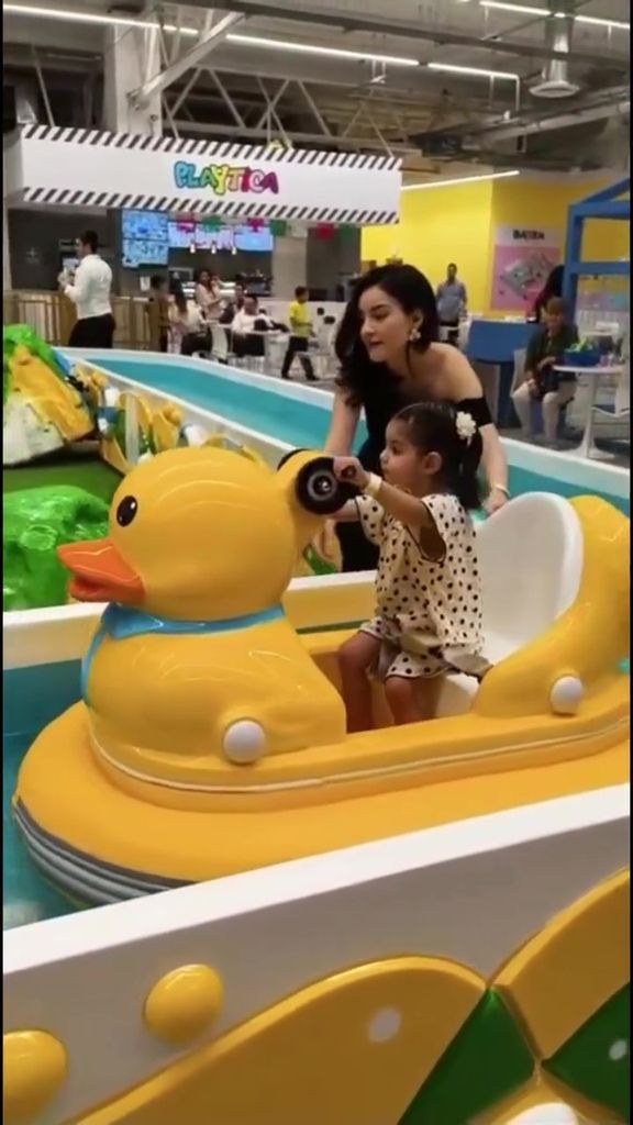 Tessa recorrió un pequeño río artificial montaba en un gran pato amarillo.
