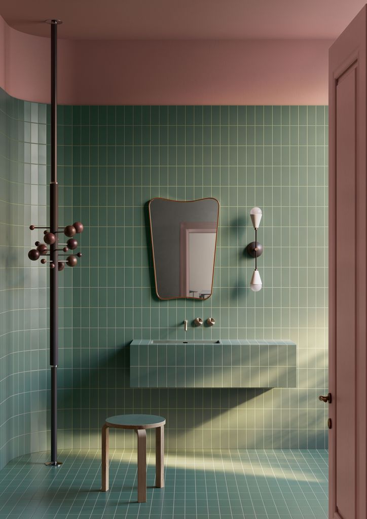 Baño con pared y suelo revestido en baldosas verdes, con lechada también verde