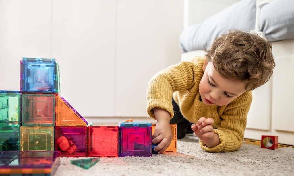 boy playing with building blocks