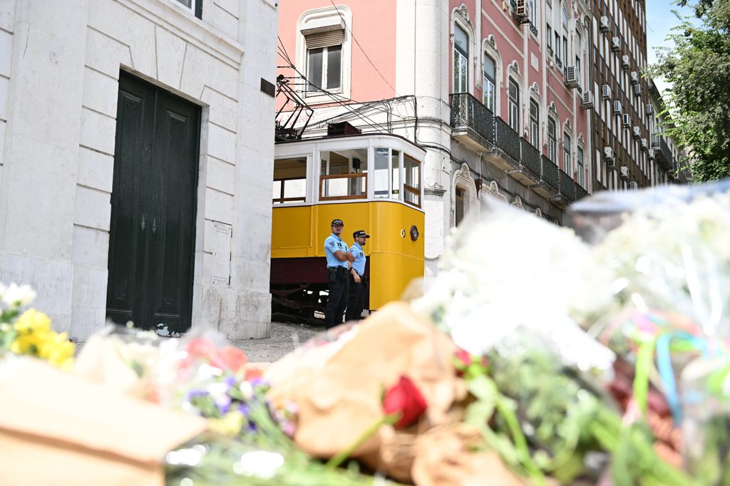 Ramos de flores y mensajes de recuerdo cubren la Calçada da Glória, convertida en improvisado altar en memoria de las víctimas del trágico accidente