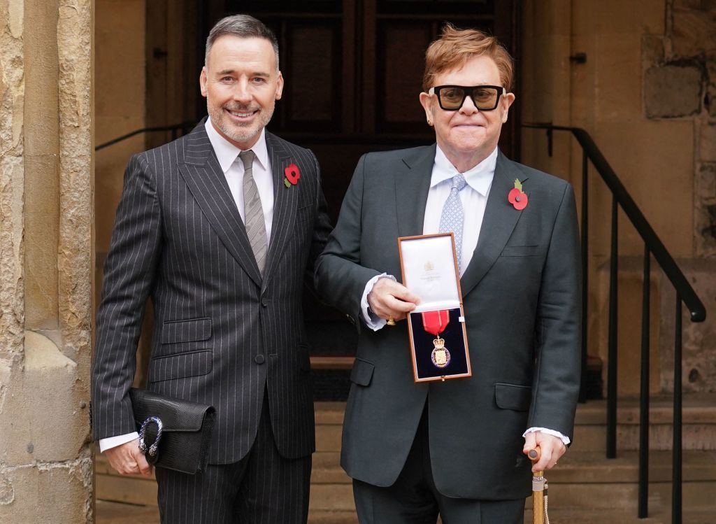 Elton John posa junto a su esposo David Furnish con su medalla tras ser nombrado miembro de la Orden de los Compañeros de Honor por sus servicios a la música y a la beneficencia en 2021