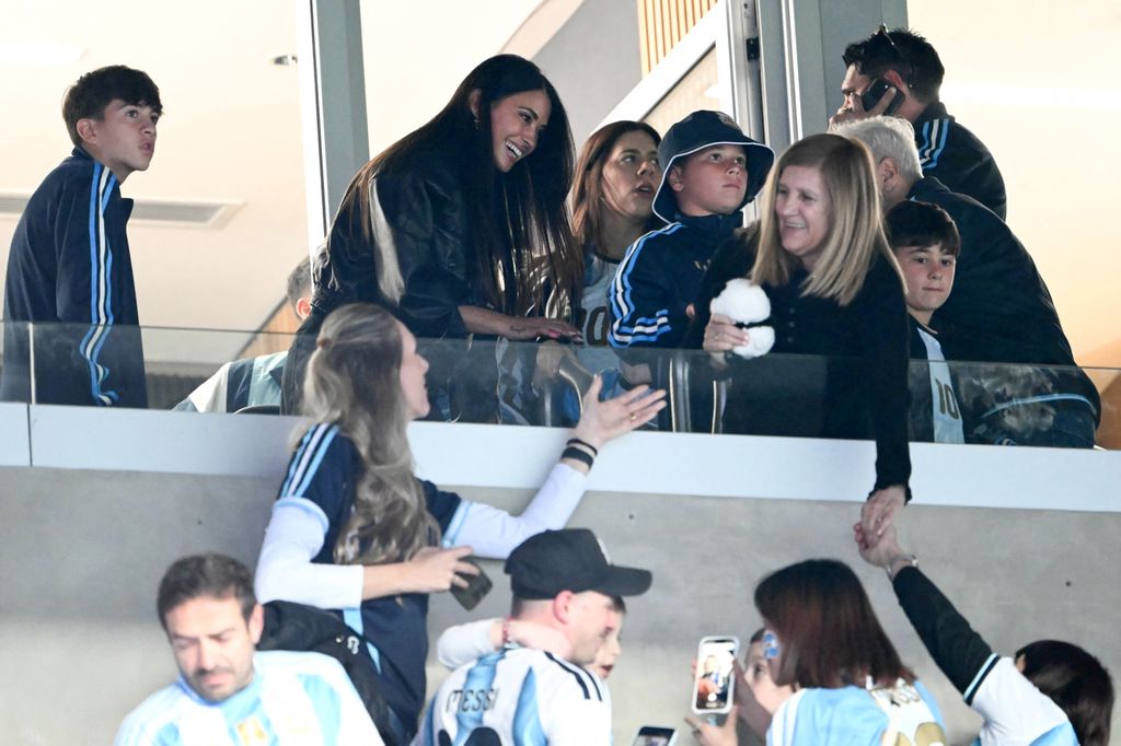 Antonela Roccuzzo (C-L) and Celia Cuccittini (C-R), wife and mother of Argentina's forward Lionel Messi, greet fans ahead of the international friendly football match between Argentina and Benin at the Mas Monumental stadium in Buenos Aires on October 6, 2026. Argentines will bid farewell to Lionel Messi with a huge "thank you" themed send-off in Buenos Aires, where the legendary captain will end his more-than-two-decade international career with a friendly against Benin. (Photo by Luis ROBAYO / AFP via Getty Images)