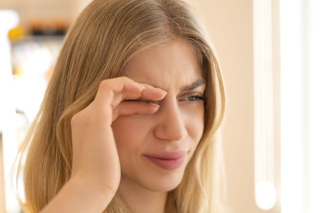 mujer con molestias en su ojo