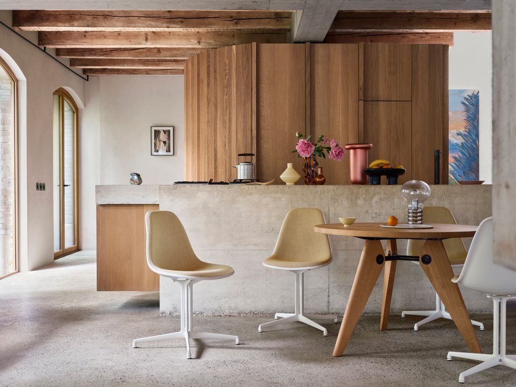 Comedor con mesa redonda de madera y sillas de diseño