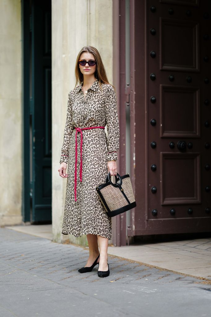 PARIS, FRANCE - JUNE 14: Segolene Hyppolite wears sunglasses, a midi slit brown and black leopard print dress from Stella Forest, a bag with geometric patterns from Rive Claire, high heels pointed shoes from Rivecour, during a street style fashion photo session, on June 14, 2024 in Paris, France. (Photo by Edward Berthelot/Getty Images)