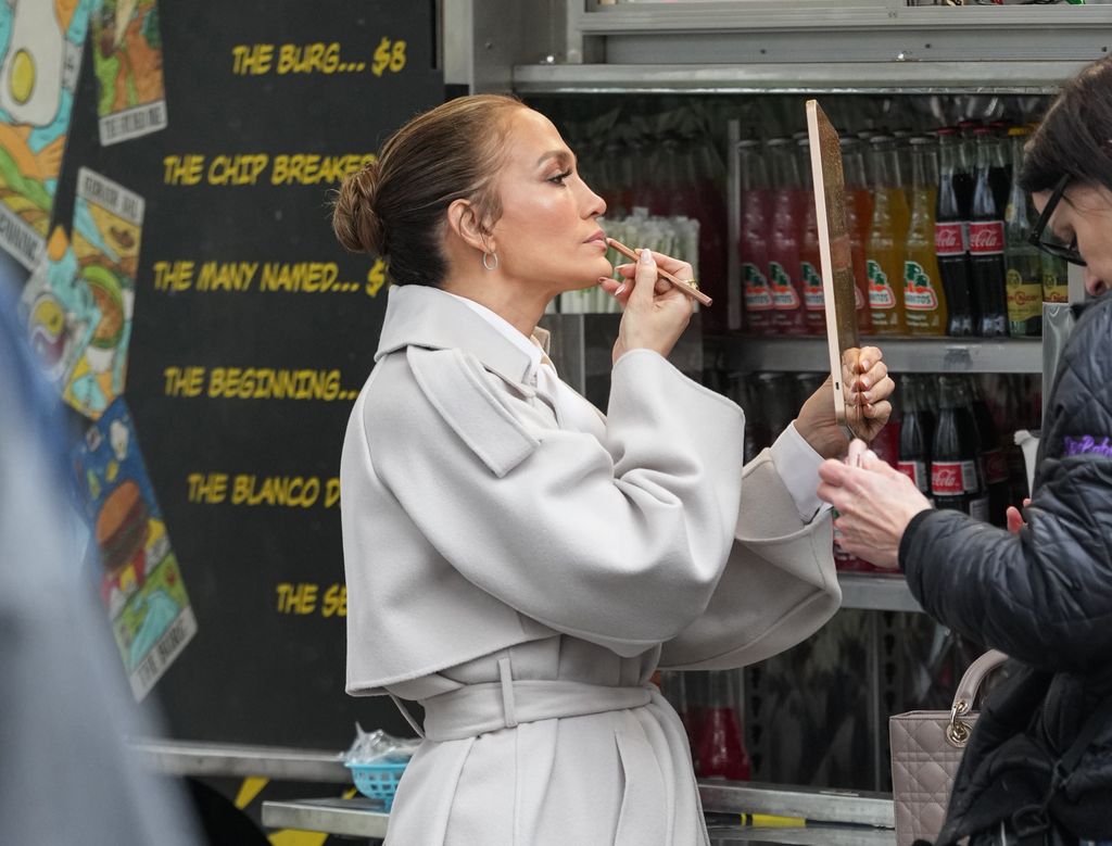Jennifer López retoca sus labios en el set de "Office Romance".