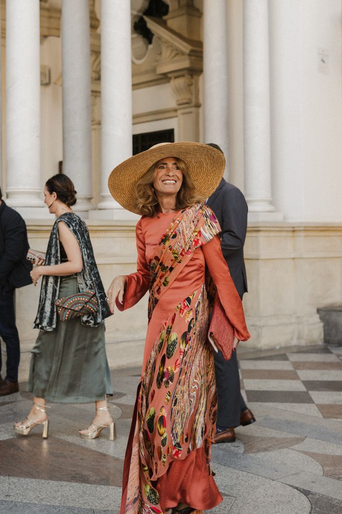 Vestido de madre de la novia coral con pamela de rafia Boda en Sevilla