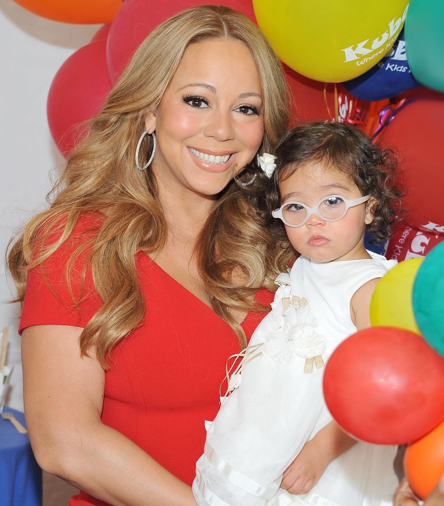 Mariah Carey and her daughter Monroe Cannon poses for pictures  during 'Family Day' hosted by Nick Cannon at Santa Monica Pier on October 6, 2012 in Santa Monica, California.  (Photo by Angela Weiss/WireImage)