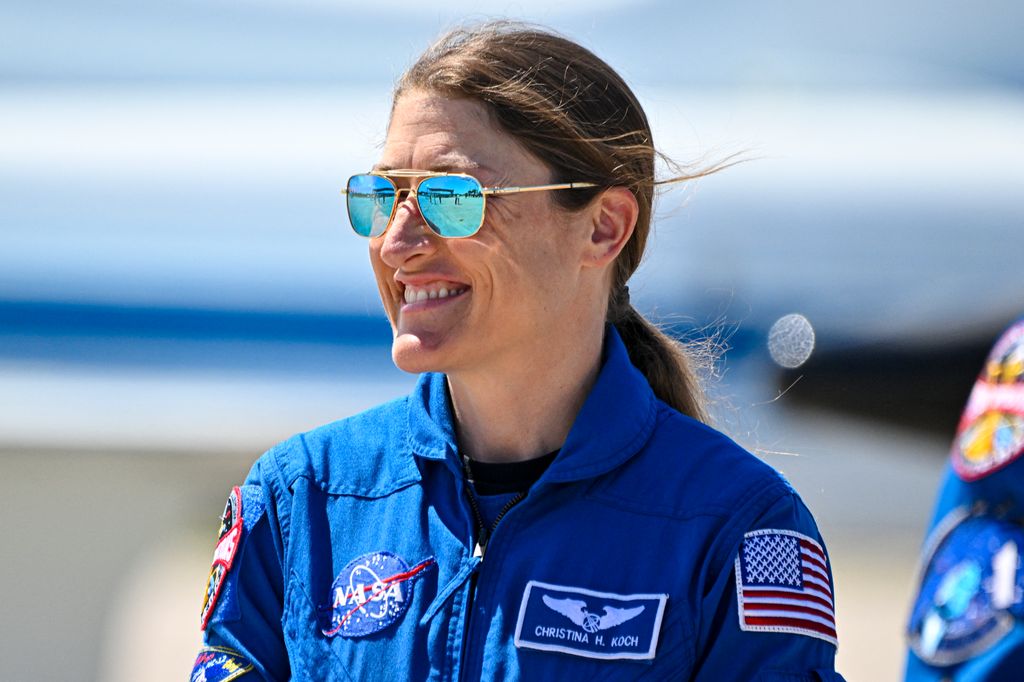 NASA astronaut and Artemis II Mission Specialist Christina Koch looks on during a welcome ceremony ahead of the Artemis II April 1 launch at Kennedy Space Center in Florida on March 27, 2026. NASA and Canadian Space Agency astronauts assigned to the Artemis II mission arrive at Kennedy Space Center in Florida on March 27, 2026, to begin final pre-launch preparations for the first crewed lunar flyby in the Artemis program. The journey, set to last around 10 days, will take the astronauts on a loop around the Moon, though they will not land on its surface. The crew comprises the first woman, the first person of color and the first non-American to take part in such a journey. (Photo by Miguel J Rodriguez Carrillo / AFP via Getty Images)