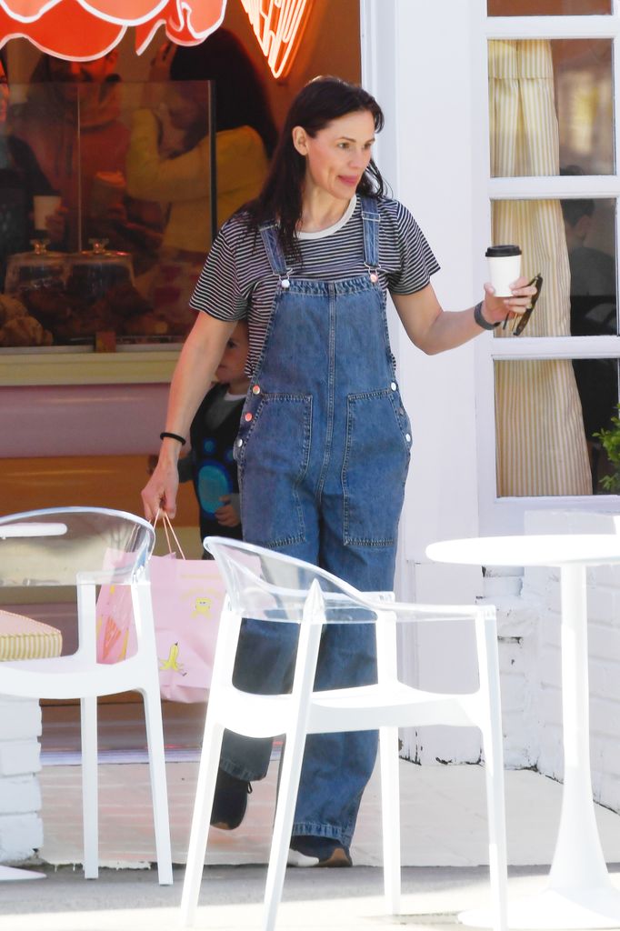 Jennifer Garner strikes a youthful pose as she steps out for coffee in Los Angeles. The 53 year old American actress, who just celebrated a birthday this week was pictured out wearing a striped top paired with denim overalls and black trainers