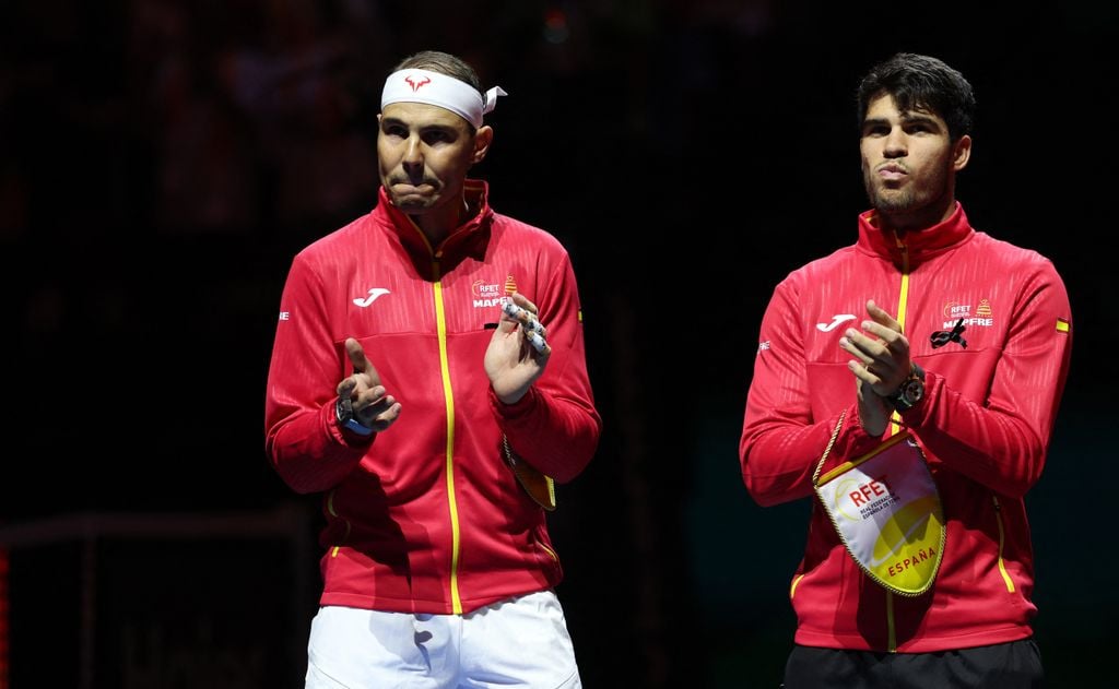 Plano medio de Rafa Nadal y Carlos Alcaraz aplaudiendo antes del partido