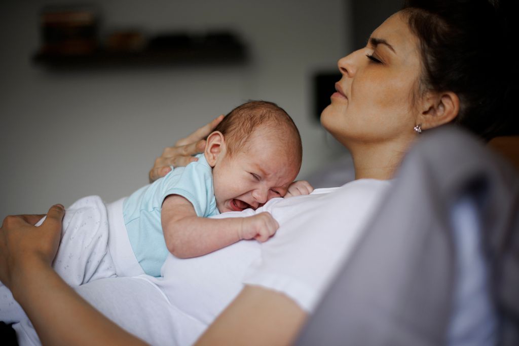Madre cansada con depresión posparto con su bebé