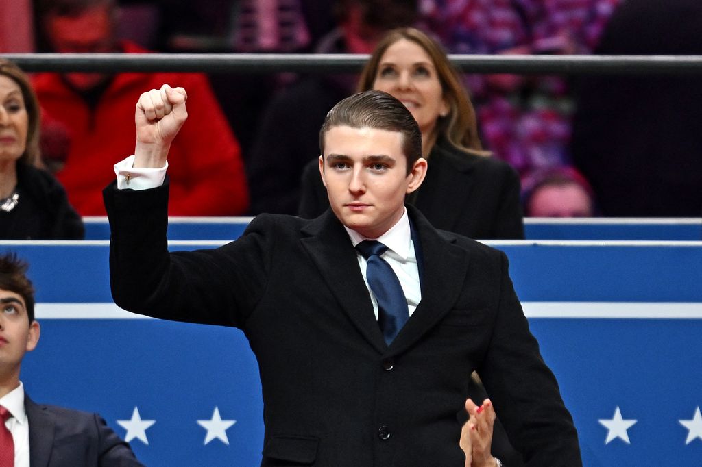 Barron Trump gestures after being acknowledged by his father US President Donald Trump during the inaugural parade inside Capital One Arena, in Washington, DC, on January 20, 2025. (Photo by ANGELA WEISS / AFP) (Photo by ANGELA WEISS/AFP via Getty Images)