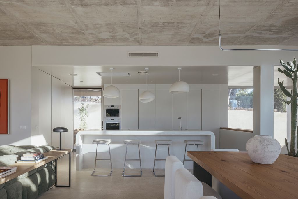 Cocina con isla blanca abierta al salón