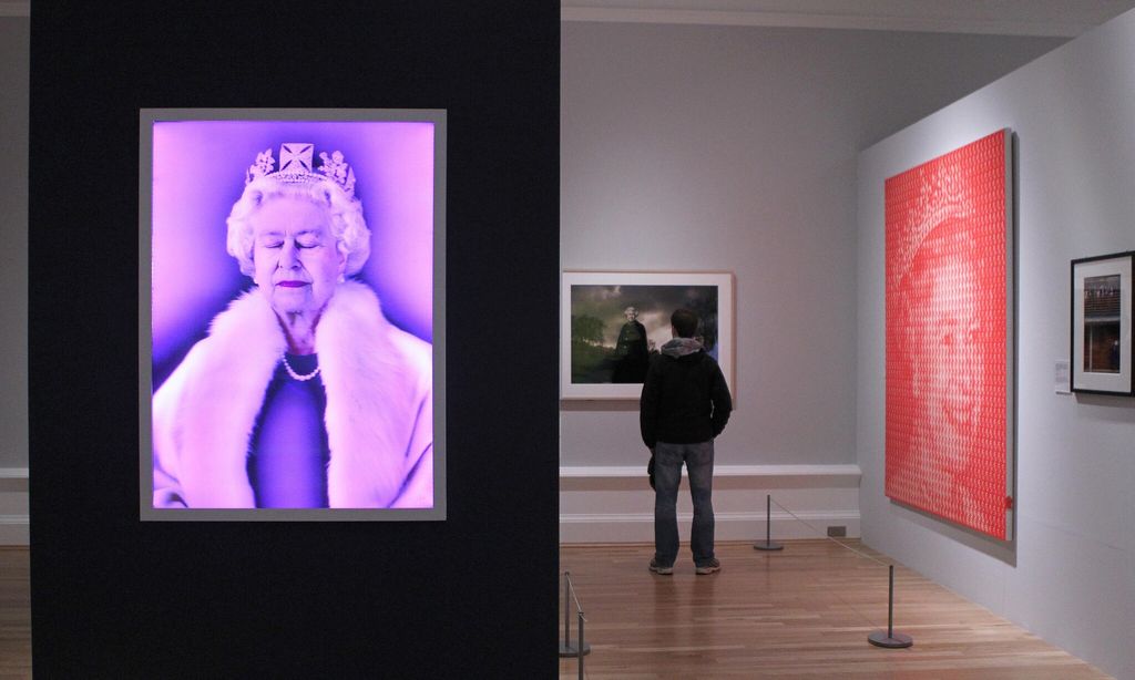 A man views a photographic portrait of B