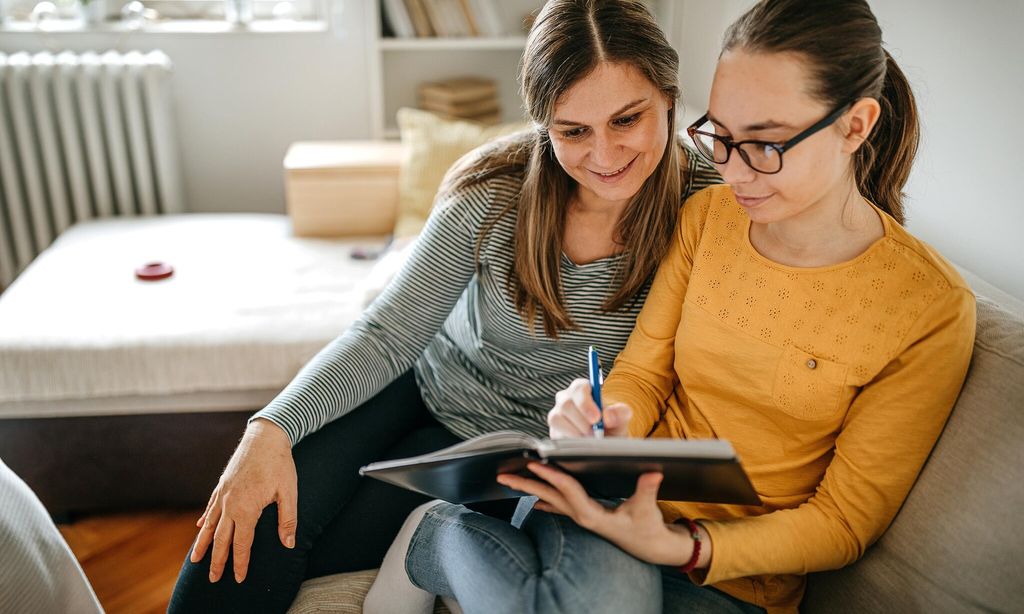mother helping daughter with homework