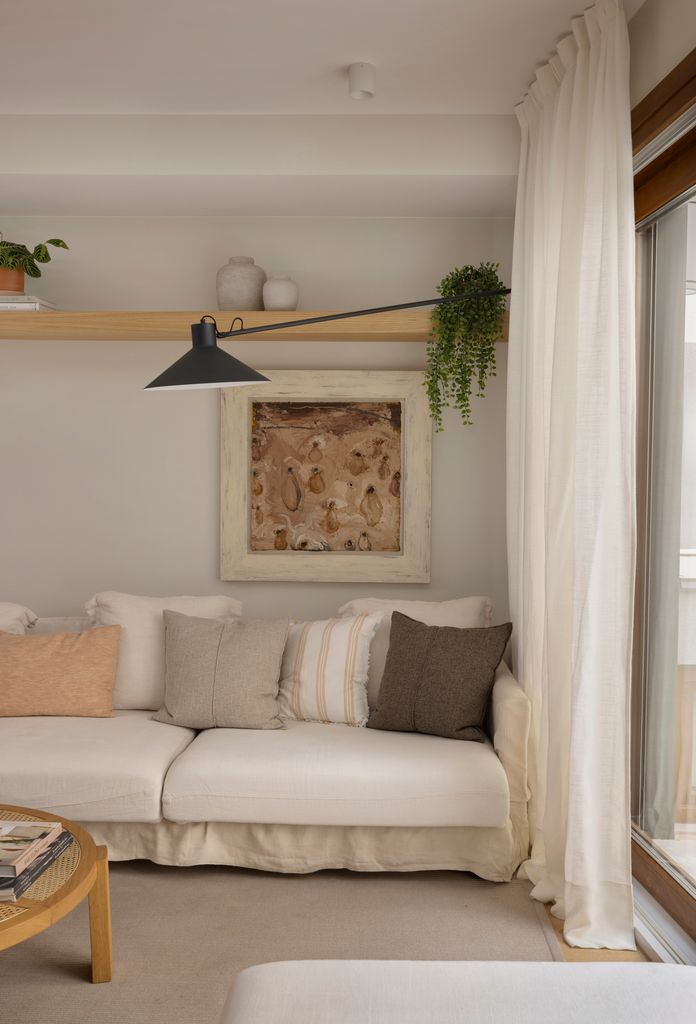 Salón cálido con sofá blanco. 
