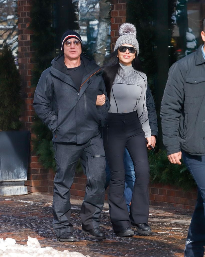 Plano medio de Jeff Bezos y Lauren Sánchez paseando por colorado con looks invernales