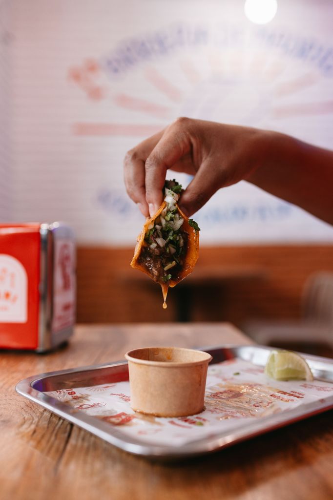 Así se come el taco de birria, mojando en el caldo