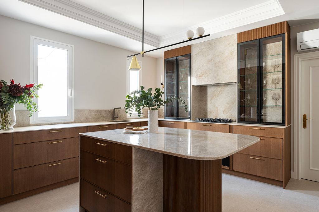 Cocina con muebles de madera y encimeras de piedra