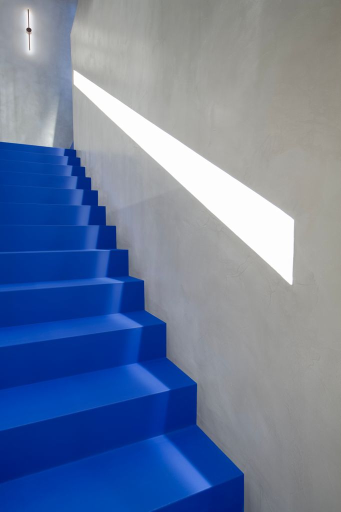 En un dúplex reformado por AdeL la escalera se convierte en absoluta protagonista gracias a la vistosa tonalidad elegida para ella: un vibrante azul eléctrico