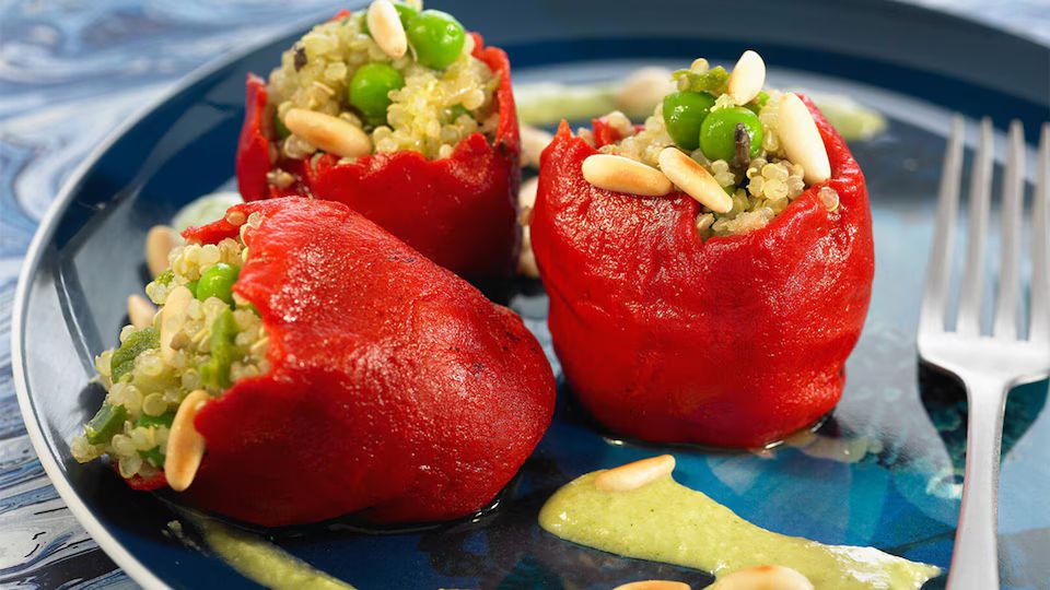 Pimientos rellenos de quinoa, piñones y guisantes