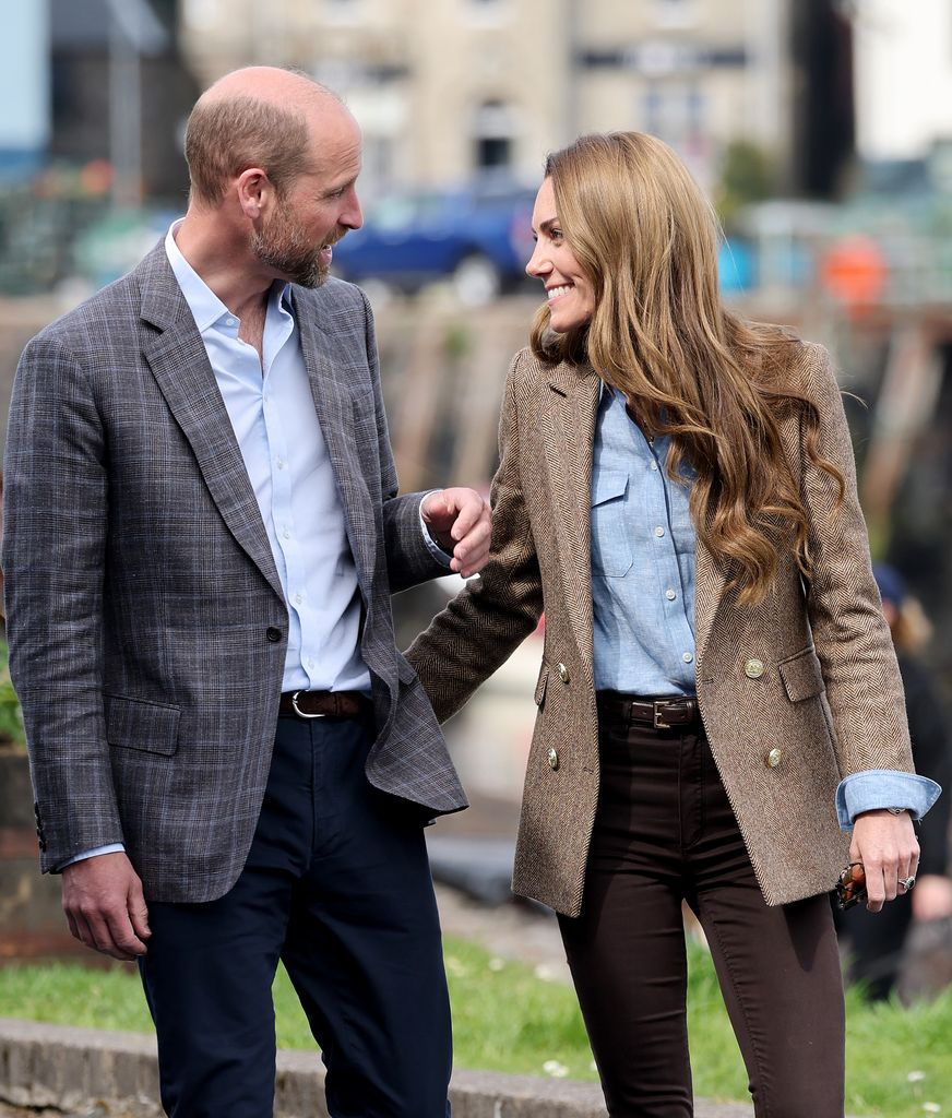 Prince William, Prince of Wales, known as the Duke of Rothesay and Catherine, Princess of Wales, known as the Duchess of Rothesay when in Scotland, smile at each other during a tour of an artisan market on April 29, 2025 in Tobermory, Scotland. The Prince and Princess of Wales are on a two-day visit to the Isles of Mull and Iona on the 29th and 30th of April to engage with rural island communities. During their time on the islands, they will connect with local residents, highlighting the value of social bonds and underscoring the importance of safeguarding and advocating for the natural environment.
