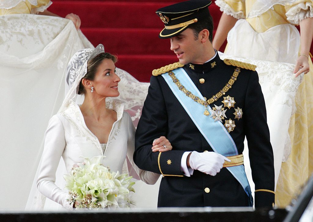 MADRID, Spain:  Princess of Asturias Letizia Ortiz and her husband Spanish Crown Prince Felipe of Bourbon smile as they leave Madrid's Almudena Cathedral at the end of their wedding ceremony 22 May 2004. AFP PHOTO POOL ODD ANDERSEN  (Photo credit should read ODD ANDERSEN/AFP via Getty Images)