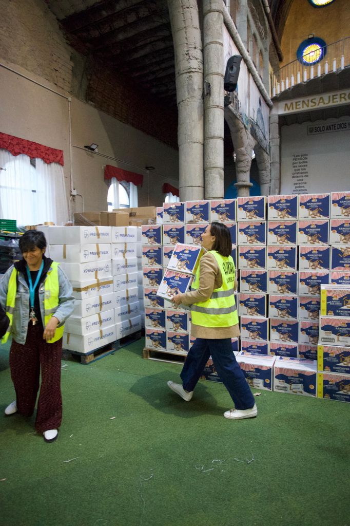 Plano medio de Tamara Falcó ayudando con la carga de un camión de alimentos